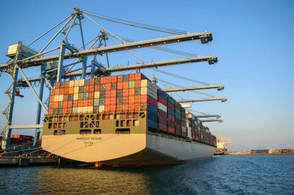 Container cargo ship at an international port terminal representing global supply chain and distribution management
